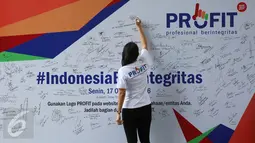 Pengunjung membubuhkan tanda tangan bentuk dukungan saat peluncuran logo PROFIT di Gedung baru KPK, Jakarta, Senin (17/10). PROFIT merupakan dukungan pengusaha swasta di dunia usaha untuk bekerjasama dengan KPK melawan korupsi. (Liputan6.com/JohanTallo)