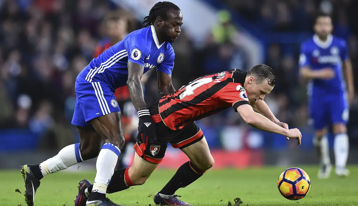 Gelandang Chelsea, Victor Moses, menjatuhkan gelandang Bournemouth, Brad Smith. Kekalahan ini membuat Bournemouth harus tertahan di peringkat ke-11 klasemen Premier League. (AFP/Glyn Kirk)