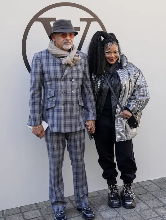 Janet Jackson berpose bersama desainer Christian Louboutin saat menghadiri koleksi busana Louis Vuitton Spring/Summer 2023 yang dipresentasikan selama Paris Fashion Week di Paris pada Selasa, 4 Oktober 2022.  Melengkapi penampilannya Jackson memakai sepasang sepatu bot tempur hitam yang menambahkan energi punk rock pada pakaiannya. Jauh dari siluet khas, sepatu bot ini menampilkan rantai logam perak yang mencolok di bagian lidah dan memiliki sol luar persegi bertumpuk dengan sol yang kokoh untuk traksi yang lebih besar. (Photo by Vianney Le Caer/Invision/AP)