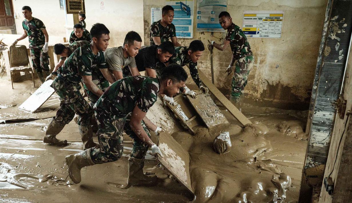Meski fasilitas fisik mulai membaik, banyak peralatan medis yang ada di Rumah Sakit Daerah Aceh Tamiang dilaporkan rusak. Tampak dalam foto, personel Tentara Nasional Indonesia (TNI) dari YONIF TP 853/BRB, Aceh Timur, membersihkan lumpur di Rumah Sakit Daerah di Aceh Tamiang, pada 16 Desember 2025, setelah banjir bandang sekitar tiga minggu lalu. (Yasuyoshi Chiba/AFP)