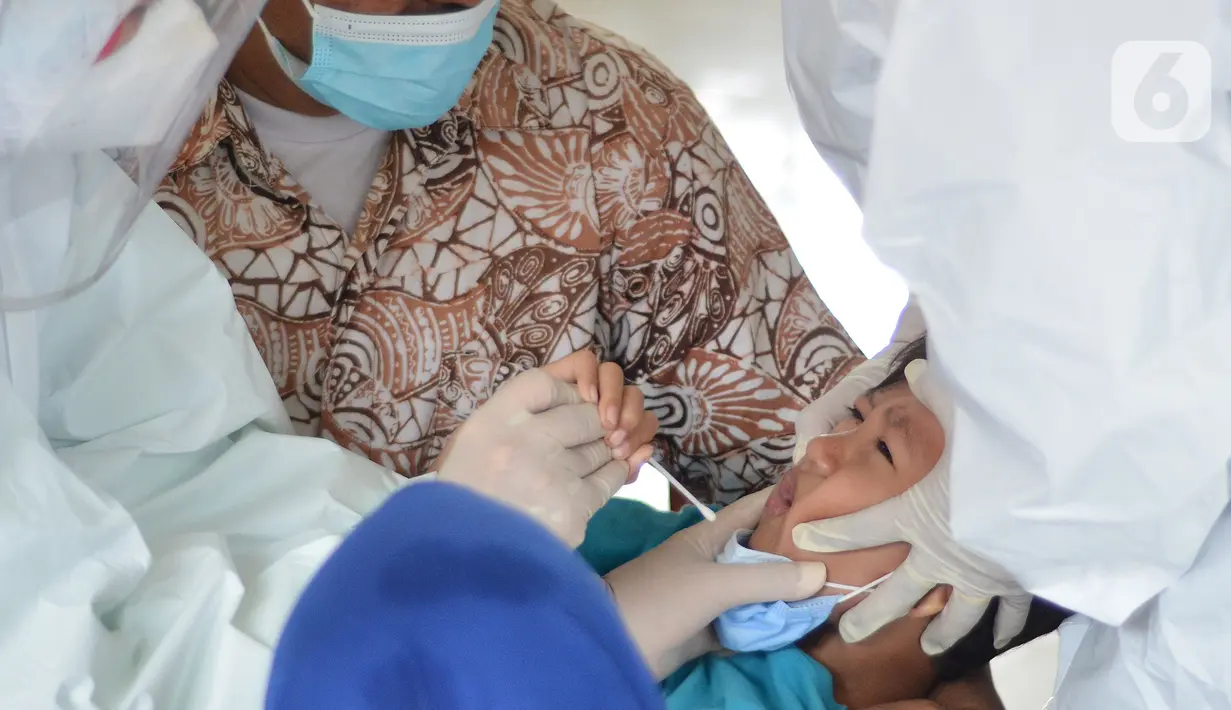 Seorang balita mengikuti tes swab PCR massal di Kantor Kecamatan Pancoran Mas, Depok, Selasa (5/1/2021). Puskesmas Pancoran Mas melakukan tes Swab PCR kepada warga yang pernah memiliki riwayat kontak erat dengan pasien terkonfirmasi positif Covid-19. (merdeka.com/Arie Basuki)
