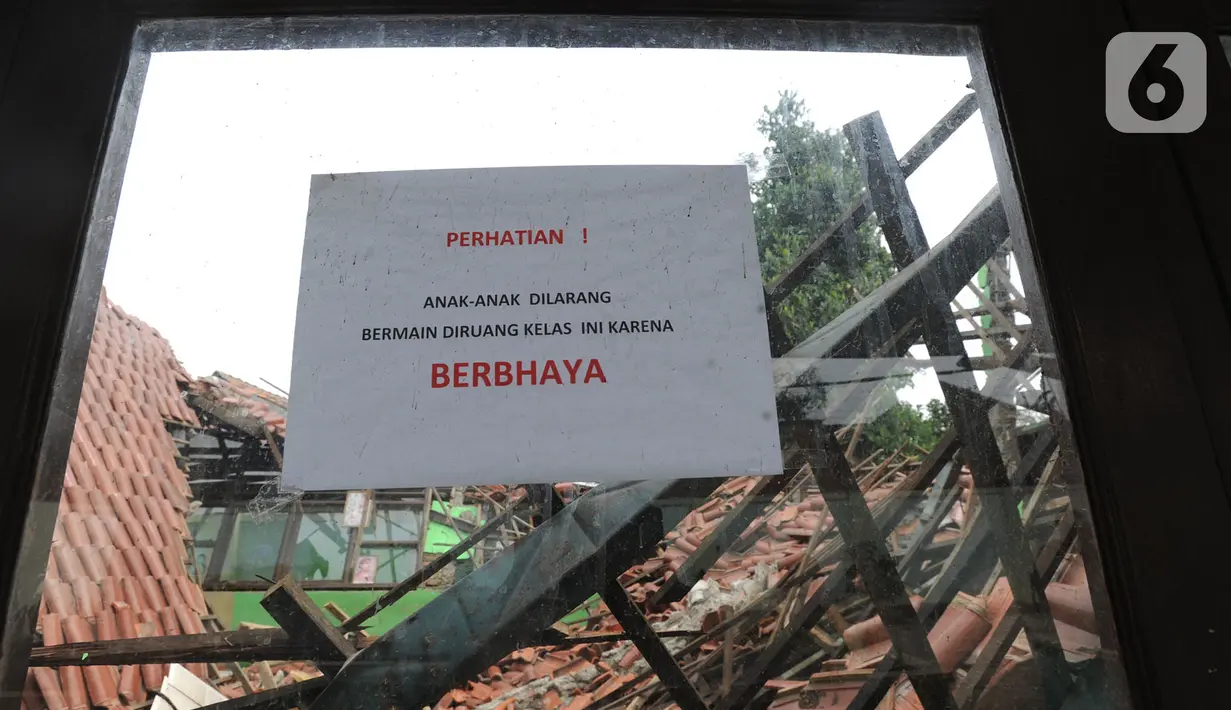 Kertas berisi pemberitahuan terpasang di salah satu jendela bangunan sekolah yang ambruk di SDN Malangnengah II, Kabupaten Tangerang, Banten, Rabu (13/11/2019). Tiga ruang kelas di SD itu roboh akibat kontur tanah di lingkungan sekolah yang ambles karena hujan. (merdeka.com/Arie Basuki)