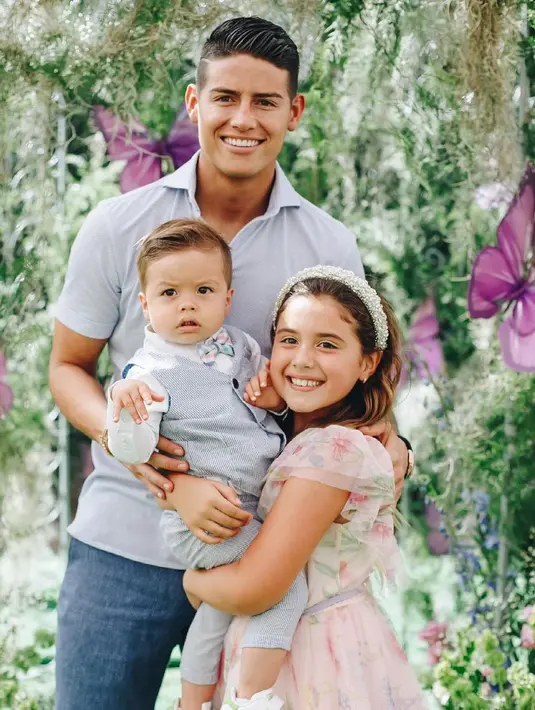 Keluarga kecil bahagia James bersama dua buah hatinya. James mengenakan atasan polo shirt berwarna abu-abu dengan celana jeans. Sedangkan Salome mengenakan dress berwarna merah muda dengan motif floral yang cantik dan Samuel digendong Salome dengan atasan kemeja putih, dilapisi vest abu-abu dan celana panjang berwarna senada, lengkap dengan dasi kupu-kupu yang imut. Foto: Instagram.