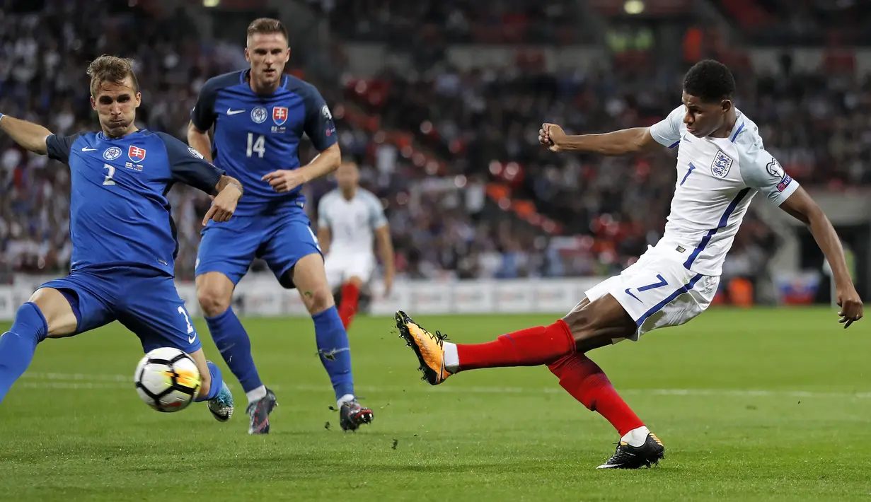 Pemain Inggris, Marcus Rashford (kanan) melepaskan tembakan melewati adangan pemain Slovakia pada laga grup F kualifikasi Piala Dunia 2018 di Wembley stadium, London, (4/9/2017). Inggris menang 2-1. (AP/Kirsty Wigglesworth)