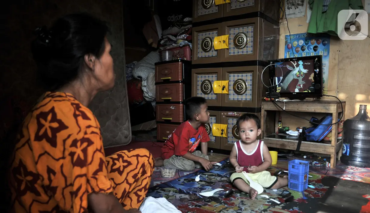 Warga menonton televisi di rumah penampungan sementara Kampung Akuarium, Penjaringan, Jakarta Utara, Senin (14/10/2019). Rumah penampungan sementara terdiri dari 3 blok dengan luas bangunan 3,5 meter x 6,5 meter dan sebagian 3,5 meter x 3,5 meter. (merdeka.com/Iqbal Nugroho)