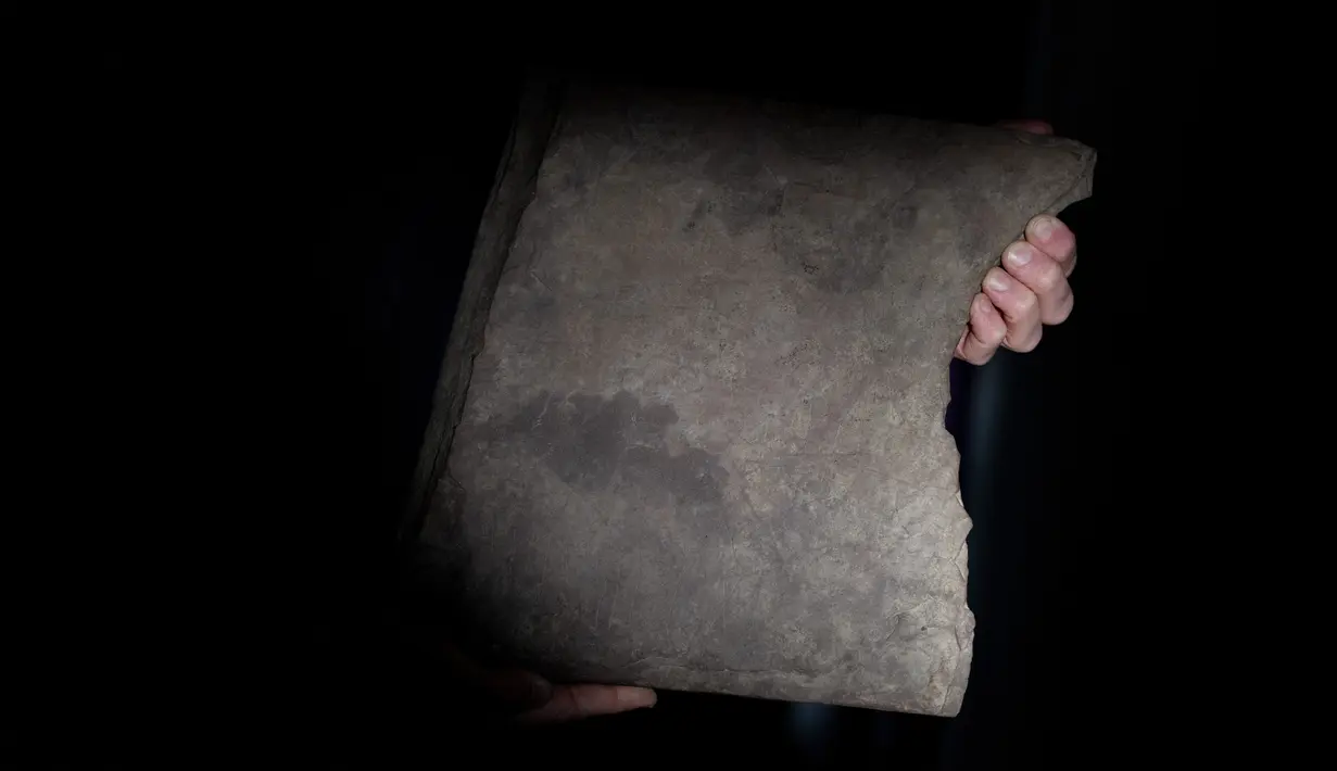 Profesor Kristel Zilmer memamerkan runestone yang ditemukan di Tyrifjorden, di Museum Sejarah Budaya di Oslo, Norwegia pada 17 Januari 2023. Batu rune itu ditemukan pada musim gugur 2021 selama penggalian kuburan di dekat Tyrifjord, sebelah barat Oslo, di wilayah yang terkenal dengan beberapa penemuan arkeologis yang monumental. (Javad Parsa / NTB / AFP)