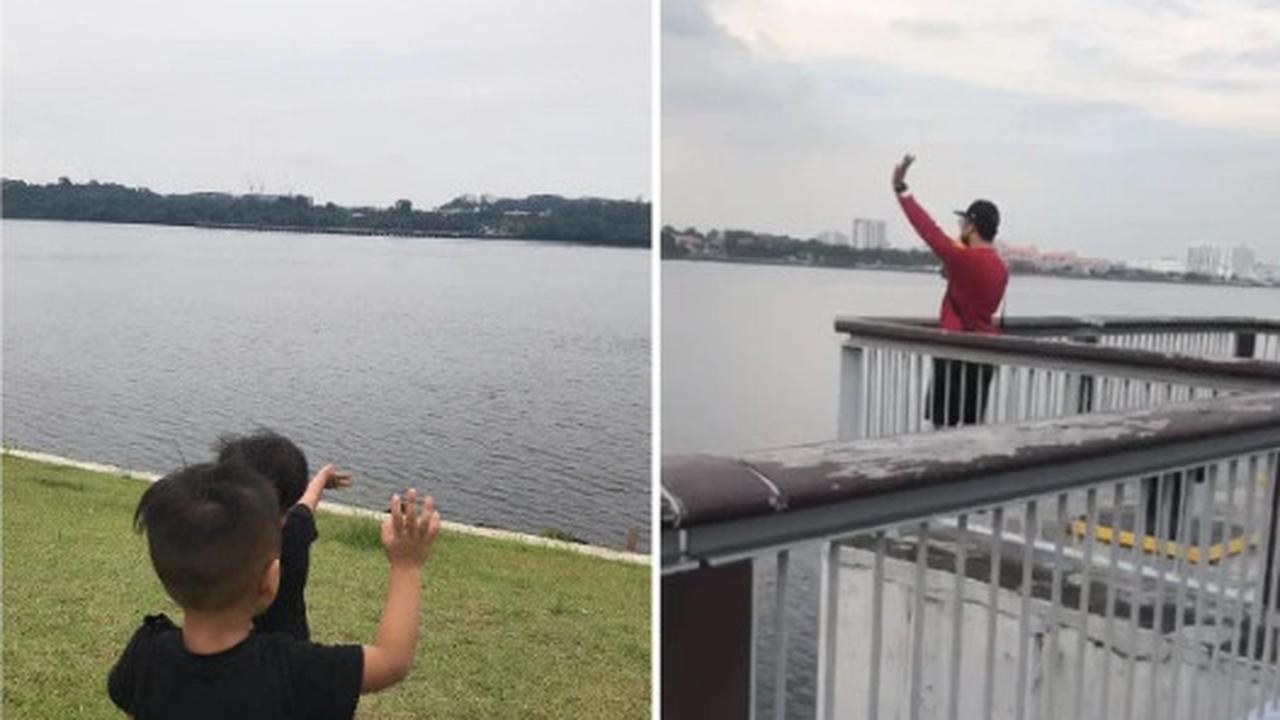 Terpisah karena Lockdown, Bapak dan Anak Saling Melambaikan Tangan dari Seberang Sungai