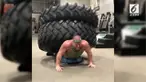 Seorang pria terekam melakukan push-up dengan memikul ebuah ban raksasa di punggungnya.