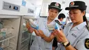Petugas BPOM China memeriksa vaksin rabies di Pusat Pengendalian dan Pencegahan Penyakit di Huaibei, provinsi Anhui, Selasa (24/7). Otoritas China menginvestigasi skandal produksi vaksin rabies ilegal yang telah menimbulkan kepanikan masyarakat. (AFP)