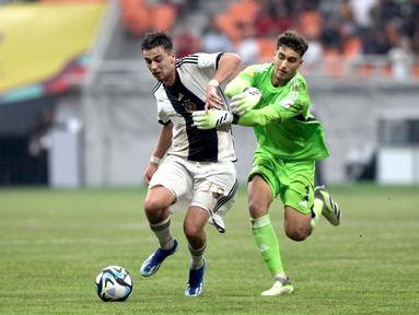Kiper Timnas Spanyol U-17, Raul Jimenez (kanan), berusaha menghentikan laju dari pemain Jerman U-17 Bilal Yalcinkaya, saat pertandingan perempat final Piala Dunia U-17 2023 yang berlangsung di Jakarta International Stadium, Jumat (24/11/2023). Atas perbuatannya, Jimenez langsung diberikan hadiah berupa kartu merah oleh wasit. (Bola.com/Arief Bagus)