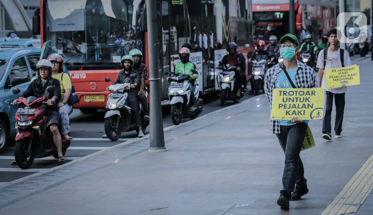 Koalisi Pejalan Kaki berjalan saat menggelar aksi di Trotoar Thamrin, Jakarta, Rabu (22/1/2020). Aksi tersebut dalam rangka memperingati Hari Pejalan Kaki Nasional pada 22  Januari, serta  mengajak pengendara untuk tertib lalu lintas serta menghormati hak pejalan kaki. (Liputan6.com/Faizal Fanani)