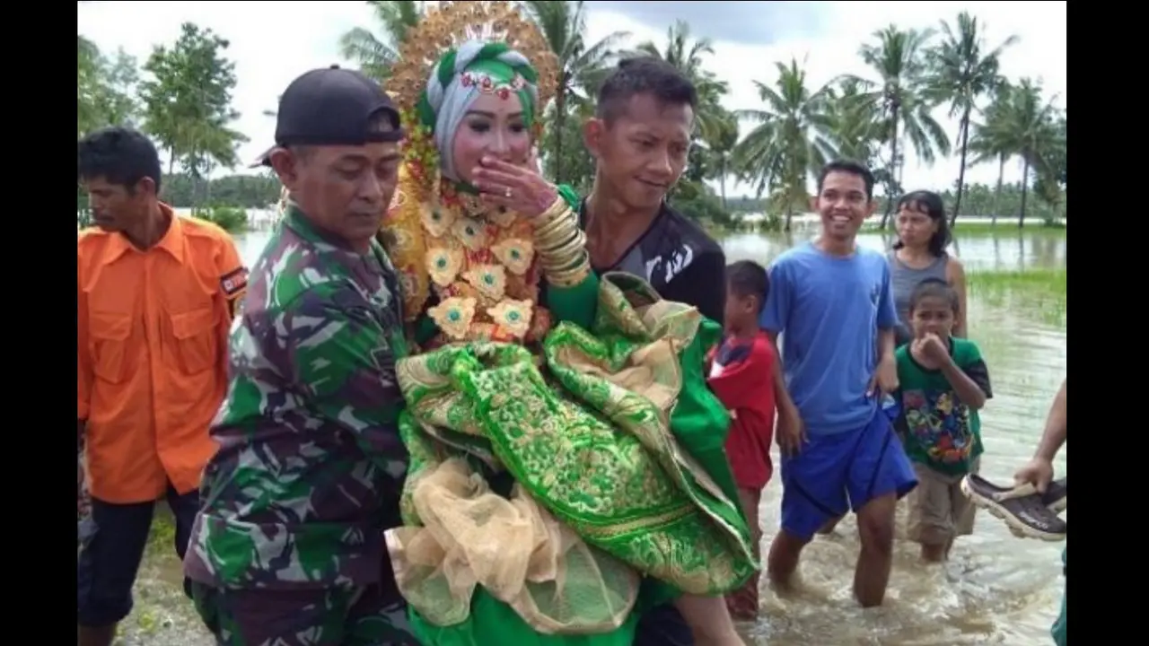 Hartina, saat digendong menuju lokasi yang tidak tergenang air (Fauzan/Liputan6.com)