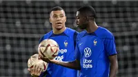 Penyerang Prancis, Ousmane Dembele (kanan) dan Kylian Mbappe ambil bagian dalam sesi latihan di Stadion Jassim-bin-Hamad di Doha, 12 Desember 2022. Prancis akan bermain melawan Maroko dalam pertandingan semifinal Piala Dunia 2022 di Stadion Al Bayt, Al Khor, Kamis (15/12/2022) pukul 02.00 WIB. (AFP/Franck Fife)