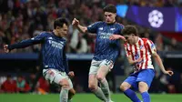 Striker Atletico Madrid, Julian Alvarez, berebut bola dengan dua pemain Arsenal Declan Rice dan Martin Zubimendi dalam pertandingan sepak bola semifinal Liga Champions leg pertama antara Club Atletico de Madrid dan Arsenal di stadion Metropolitano di Madrid pada Kamis (30/4/2026). (Javier SORIANO / AFP)