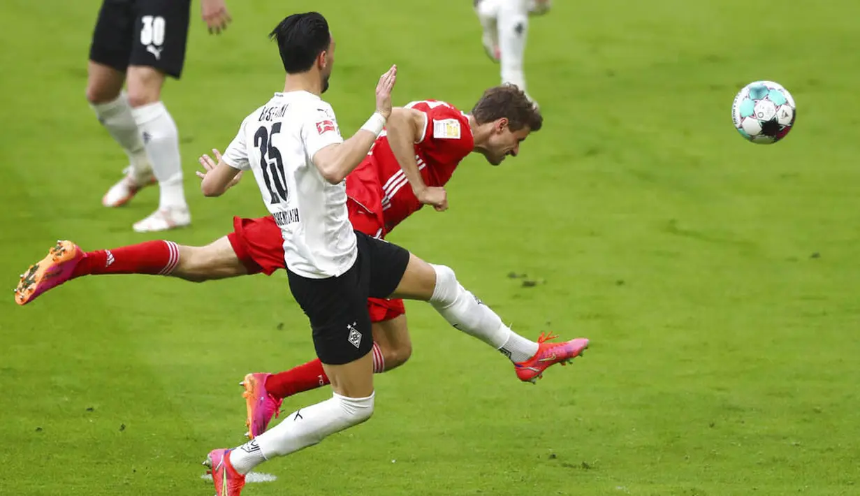 Penyerang Bayern Munchen, Thomas Mueller, menyundul bola saat melawan Moenchengladbach pada laga Liga Jerman di Allianz Arena, Sabtu (8/5/2021). Bayern Munchen menang enam gol tanpa balas. (AP/Matthias Schrader, Pool)