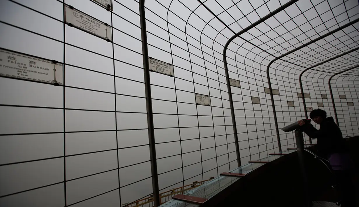 Kabut asap menyelimuti Lapangan Tiananmen, Beijing, Rabu (15/1/2015). Seorang pengunjung saat melihat kabut asap di menara observatorium di Beijing.  (REUTERS/Kim Kyung-Hoon)