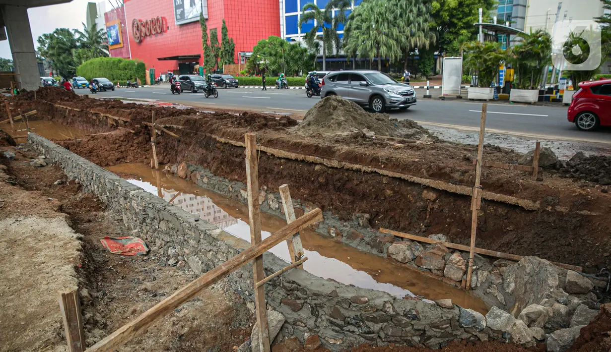 Suasana proyek pembangunan kolam olakan air di Kelapa Gading, Jakarta, Minggu (31/1/2021). Pembuatan kolam olakan air ini dilakukan untuk mengantisipasi dan menampung genangan air sementara di jalan raya saat hujan, yang kemudian akan dialirkan ke sungai atau laut. (Liputan6.com/Faizal Fanani)