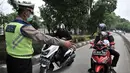 Polisi memberhentikan sepeda motor yang melintasi jalur bus Transjakarta di Jalan Yos Sudarso, Jakarta, Senin (21/1). Razia ini sekaligus meningkatkan kedisiplinan dalam berkendara. (Merdeka.com/Iqbl Nugroho)