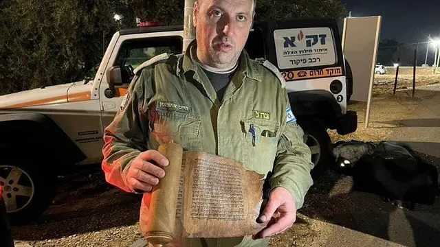 Tim SAR Israel dari ZAKA memegang manuskrip Yahudi berusia 200 tahun dari sinagoge di Antakya, Provinsi Hatay, Turki.