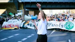 Aktivis iklim Luisa Neubauer memotivasi para demonstran saat protes ''Fridays for Future'' di Berlin, Jerman, Jumat (15/9/2023). Dilansir dari Reuters, jumlah orang yang turun ke jalan dalam Global Climate Strike 2023 di seluruh dunia secara total diperkirakan mencapai lebih dari 1 juta orang selama tiga hari. (Annette Riedl/dpa via AP)