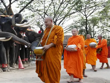 Sejumlah Biksu Buddha memberi pemberkatan kepada gajah saat perayaan Hari Gajah Nasional di kota bersejarah, Thailand, (3/11). Gajah merupakan ikon di negara Thailand. (REUTERS / Chaiwat Subprasom)