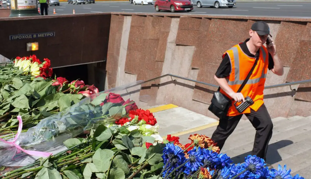 Deretan bunga memenuhi pintu masuk Stasiun Park Pobedy, Moskow, lokasi tergelincirnya kereta bawah tanah yang menewaskan 20 penumpang, (16/7/2014). (AFP PHOTO/Alexander Nemenov)
