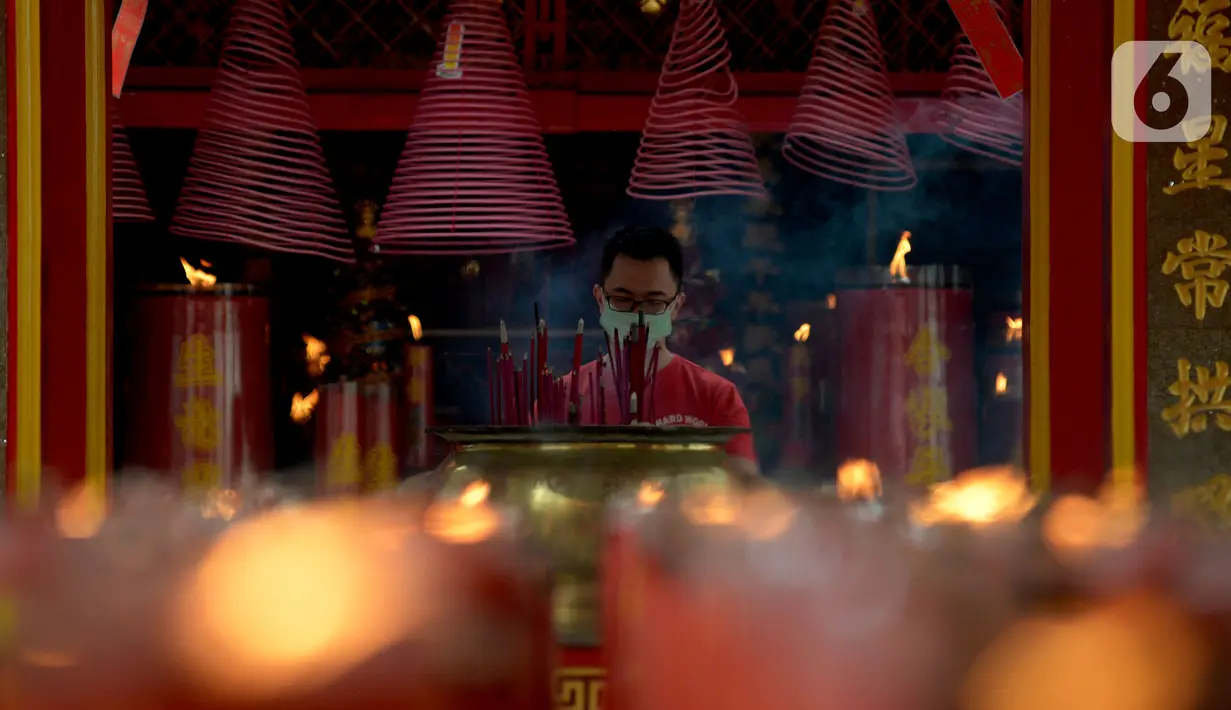 Warga keturunan Tionghoa melakukan sembahyang saat perayaan Tahun Baru Imlek 2572 di Vihara Dharma Bhakti, Glodok, Jakarta, Jumat (12/2/2021). Perayaan Imlek tahun ini, pengurus vihara melakukan pembatasan pengunjung dan tetap mengikuti protokol kesehatan COVID-19. (merdeka.com/Imam Buhori)