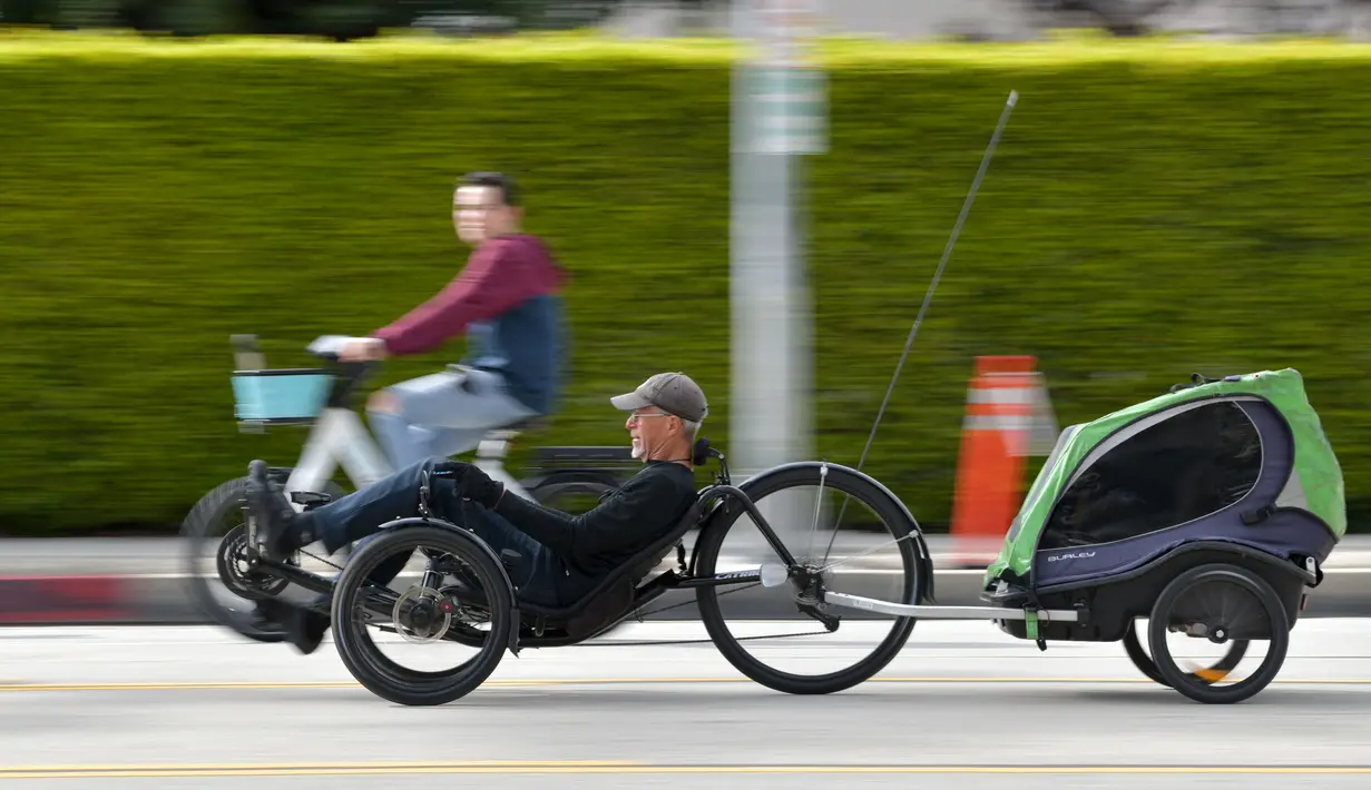 Seorang pria mengendarai sepeda telentang di jalan bebas kendaraan bermotor selama acara CicLAvia di Culver City, Los Angeles, AS, Minggu (3/3). Acara ini pertama kali diadakan pada tahun 2010 silam. (Chris Delmas/AFP)