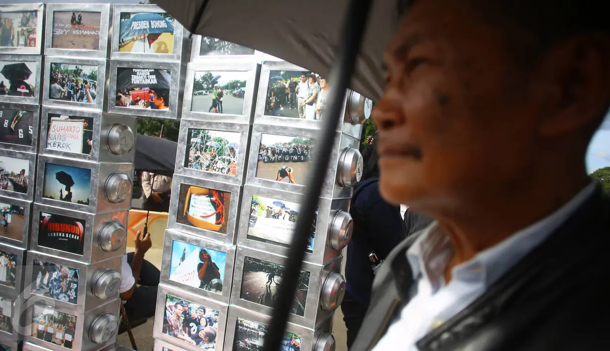 Salah satu peserta Aksi Kamisan membawa payung yang menjadi ciri khas dari aksi tersebut saat berlangsung di depan Istana Negara, Jakarta, Kamis (19/1). (Liputan6.com/ Immanuel Antonius)