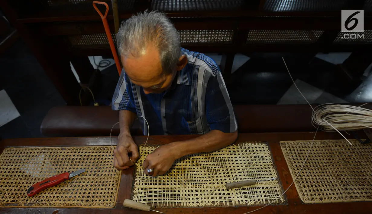 Samin (72) merajut anyaman kursi rotan ibadah umat Kristen di Gereja Katedral, Jakarta, Rabu (27/3) Bilau kerap melakukan perawatan kursi-kursi Katedral yang terbuat dari kayu Jati dengan anyaman rotan. Sudah 8 tahun untuk memberikan kenyamanan untuk bisa beribadah dengan baik. (merdeka.com/Imam Buh