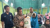 Encin Warga Bojong Purwakarta tersenyum bahagia saat menerima bantuan beras dari pemerintah. (Ist)