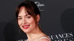 Dakota Johnson tersenyum saat menghadiri penayangan perdana film terbarunya, Fifty Shades Freed di Paris, Prancis (6/2). Fifty Shades Freed diadaptasi dari sebuah novel Fifty Shades Freed yang ditulis oleh E. L. James. (AP Photo/Francois Mori)