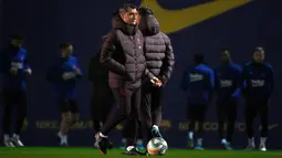 Pelatih Barcelona, Ernesto Valverde (tengah) melihat para pemainnya mengikuti sesi latihan di Joan Gamper Sports City di Sant Joan Despi (17/12/2019). Barcelona akan bertanding melawan Real Madrid dalam laga El Clasico di Camp Nou. (AFP/Lluis Gene)