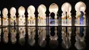 Pengunjung berjalan di lorong Masjid Agung Sheikh Zayed ketika persiapan salat tarawih pertama di Abu Dhabi, Rabu (17/5). Masjid ini dibangun oleh presiden pertama Uni Emirat Arab, yaitu Sheikh Zayed bin Sultan Al Nahyan. (AFP PHOTO/KARIM SAHIB)
