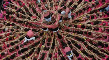 Anggota "Colla Vella dels Xiquets de Valls" membentuk menara manusia selama Kompetisi Tower Manusia di Tarragona, Spanyol, Minggu (7/10). Tradisi "Castells" atau "Menara Manusia" ini berasal dari tradisi di Catalonia pada abad ke-18. (AP/Emilio Morenatti)