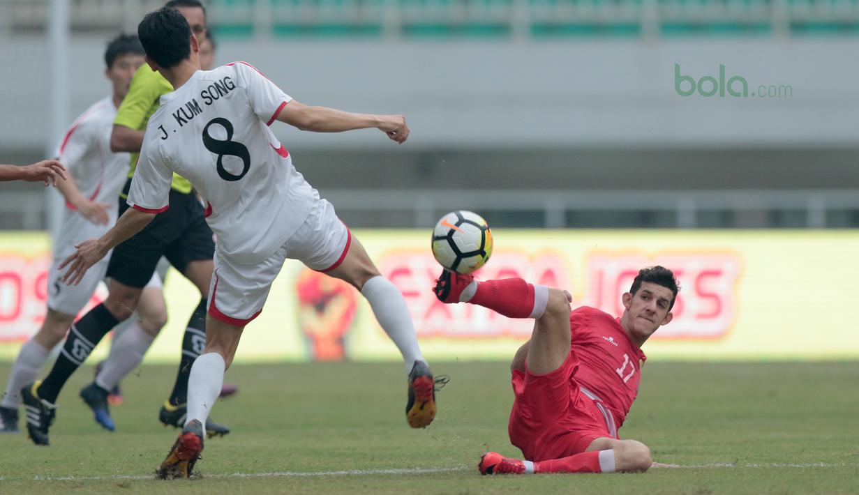 Aksi pemain Bahrain U-23, Jasim Alsalama (kanan0 menghalau bola dari kaki pemain Korea Utara U-23 pada laga PSSI Anniversary Cup 2018 di Stadion Pakansari, Bogor, (03/5/2018). Bahrain unggul sementara 1-0. (Bola.com/Nick Hanoatubun)
