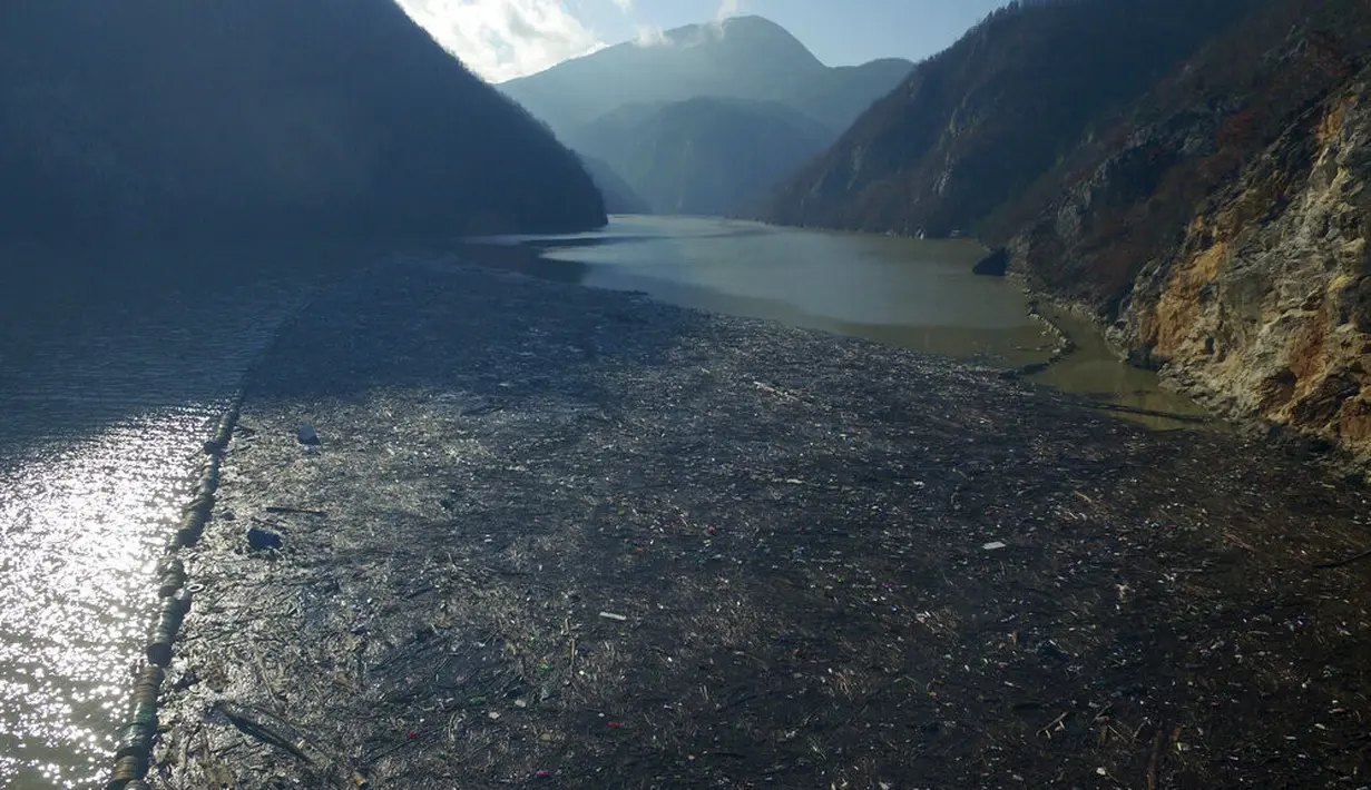 Foto dari udara memperlihatkan hamparan sampah menyumbat Sungai Drina dekat Kota Visegrad, Bosnia, Selasa (5/1/2021). Hamparan limbah terdiri dari sampah botol plastik, papan kayu, tong berkarat, dan lainnya. (AP Photo/Eldar Emric)