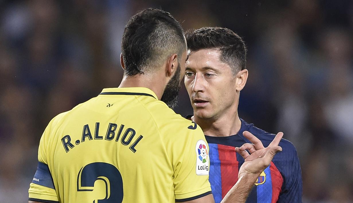 Dalam pertandingan tersebut terlihat ketegangan antara Robert Lewandowski dan Raul Albiol. Terlebih lagi, Lewy sempat menggocek kapten Villarreal tersebut dengan telak pada proses gol pertama Barcelona. (AFP/Josep Lago)