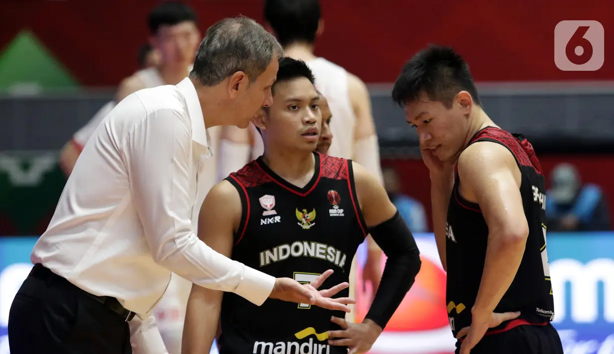 Pelatih Timnas Basket Indonesia, Milos Pejic (kiri) memebri arahan pada Andakara Prastawa Adhyaksa (tengah) saat melawan China pada laga playoff perempat final FIBA Asia Cup 2022 di Istora Senayan, Jakarta, Senin (18/7/2022). Timnas basket Indonesia tersingkir dari ajang FIBA Asia Cup 2022 usai menelan kekalahan telak 58-108 dari China. (Liputan6.com/Helmi Fithriansyah)