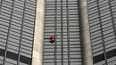 Alain Robert, pendaki bangunan pencakar langit asal Prancis memanjat Menara Montparnasse di Paris, Prancis, Rabu (12/10/2022). Alain Robert yang dikenal sebagai Spiderman Prancis itu kembali beraksi dengan memanjat Menara Montparnasse yang memiliki ketinggian 210 meter. (Bertrand GUAY/AFP)