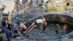 Para tentara Irak saat berada di kolam belerang di Hammam al-Ali, Mosul, Irak, (9/11). Di tengah perang melawan ISIS, mereka melepaskan penat dan lelah dengan berenang di Kolam belerang. (REUTERS/Alaa Al-Marjani)