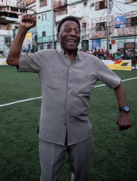 <p>Mantan pemain sepak bola asal Basil, Edson Arantes do Nascimento atau Pele mengangkat tinjunya saat upacara peresmian lapangan sepak bola berteknologi baru yang dipasang di Favela Mineira, Rio de Janeiro, Brasil, 10 September 2014. Pele memiliki segudang rekor di Piala Dunia yang belum bisa dipecahkan hingga tahun 2022 ini, seperti pemenang Piala Dunia termuda di usia 17 tahun dan 249 hari dan pencetak gol termuda di Piala Dunia berkat golnya ke gawang Wales di umur 17 tahun dan 239 hari. (Yasuyoshi CHIBA/AFP)</p>