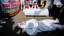 Pengunjuk rasa dari tenaga medis dan kesehatan melakukan aksi teatrikal di depan gedung MPR/DPR-DPD, Senayan, Jakarta, Selasa (11/7/2023). (Liputan6.com/Faizal Fanani)