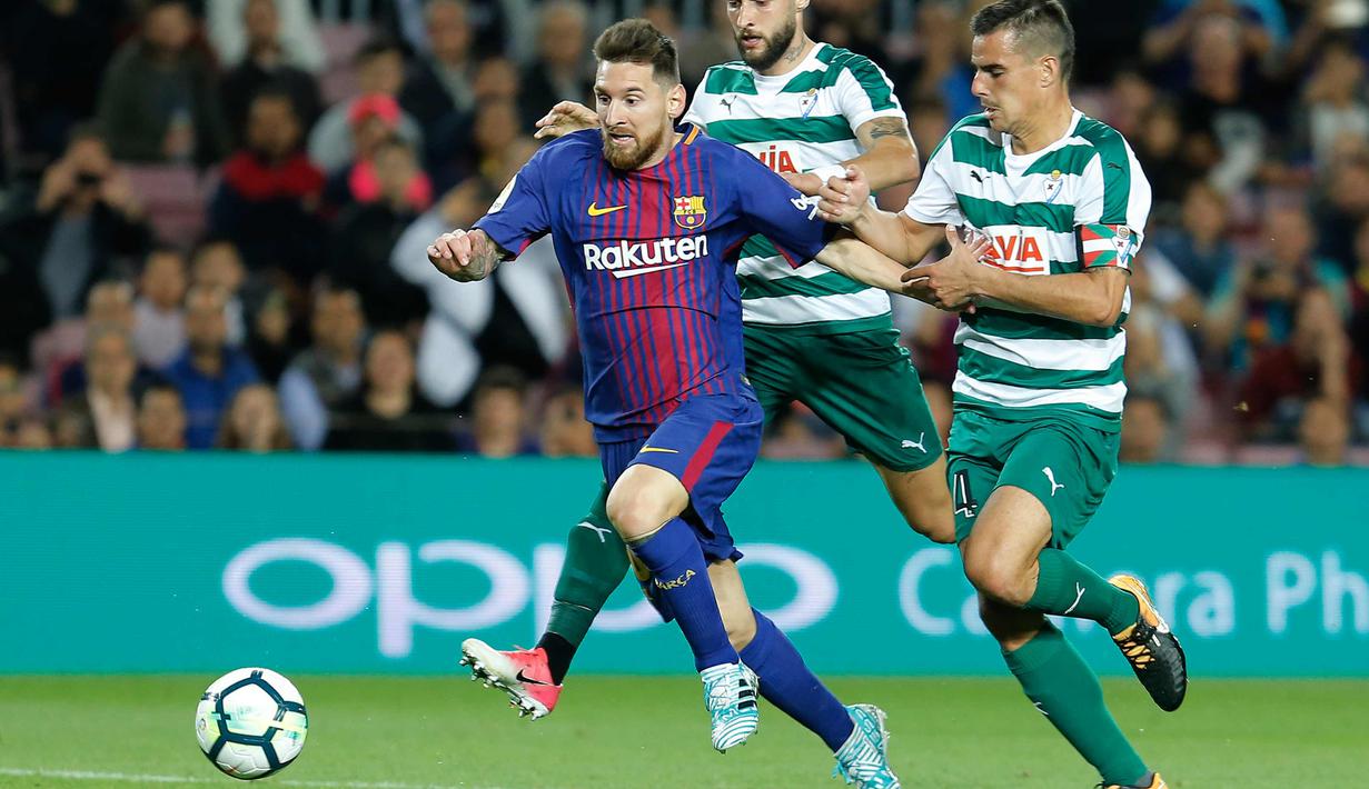 Aksi Lionel Messi saat membawa dari kejaran pemain Eibar pada pertandingan La Liga Spanyol di stadion Camp Nou di Barcelona, Spanyol, (19/9). Barcelona menang telak 6-1 atas SD Eibar. (AFP Photo/Pau Barrena)