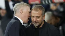 Pelatih Real Madrid, Carlo Ancelotti dan pelatih Barcelona, Hansi Flick berinteraksi dalam laga El Clasico di Estadio Santiago Bernabeu, Senin (27/10/2024) dini hari WIB. (AFP/Oscar Del Pozo)