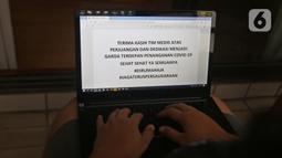 Seorang jurnalis mengetik tulisan dukungan di kawasan Halim, Jakarta, Senin (23/3/2020). Warga memberikan dukungan kepada tenaga medis yang berjuang dan berdedikasi dalam penanganan Covid-19. (Liputan6.com/Herman Zakharia)