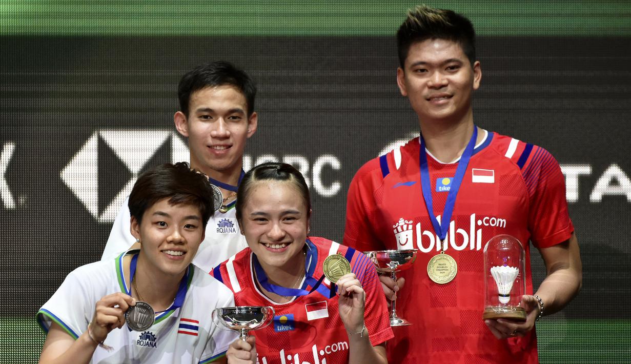 Pasangan Indonesia, Praveen Jordan/Melati Daeva Oktavianti melakukan selebrasi usai meraih juara All England 2020 dengan mengalahkan wakil Thailand Dechapol Puavaranukroh/Sapsiree Taerattanachai di Birmingham Arena, Minggu (15/3/2020). (AP/Rui Vieira)
