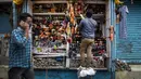Seorang penjaga toko menata sepatu di Gauhati, India, Rabu (9/6/2021). India melonggarkan sebagian pembatasan untuk mengekang penyebaran virus corona COVID-19. (AP Photo/Anupam Nath)