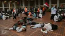 Ribuan umat muslim dari berbagai daerah sedang beristirahat usai melakukan perjalanan dan menjalankan salat Shubuh di Masjid Istiqlal, Jakarta. (04/10). Lebih dari 70 bus berukuran besar berjejer di kompleks Masjid Istiqlal. (Liputan6.com/Johan Tallo)