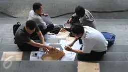 Sejumlah pelamar menyiapkan berkas saat menghadiri Job for Career di Stadion Gelora Bung Karno Jakarta, Rabu (30/9/2015). Tingginya angka pencari kerja menjadikan bursa kerja ramai peminat. (Liputan6.com/Helmi Fithriansyah)